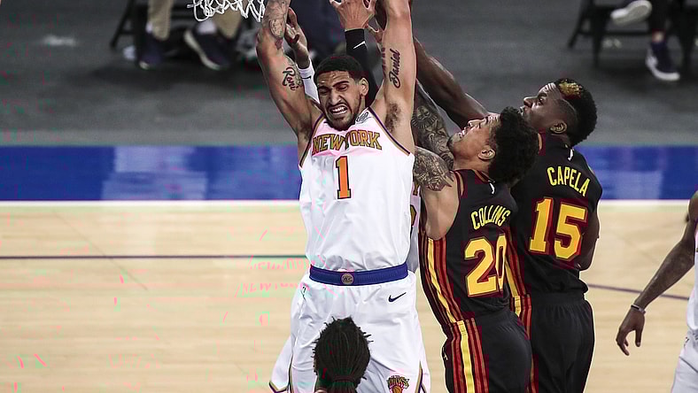 Apr 21, 2021; New York, New York, USA; New York Knicks forward Obi Toppin (1) grabs a rebound against Atlanta Hawks forward John Collins (20) and center Clint Capela (15) in the second quarter at Madison Square Garden. Mandatory Credit: Wendell Cruz-USA TODAY Sports