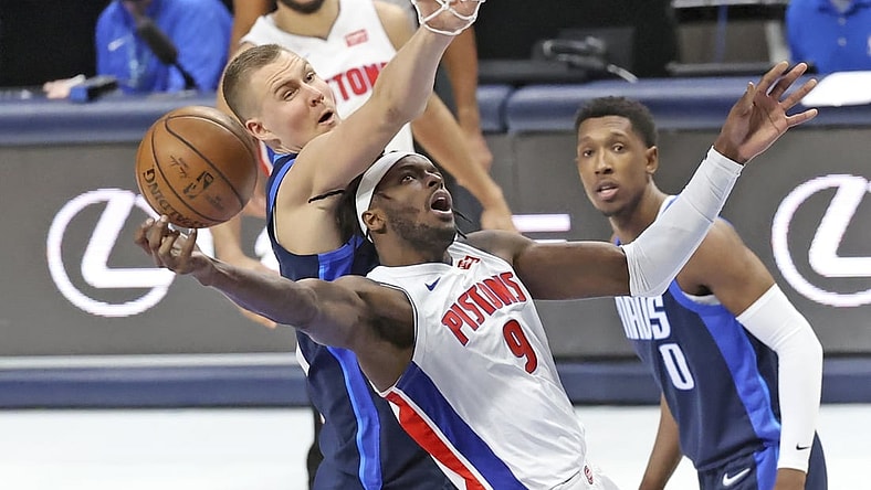 Apr 21, 2021; Dallas, Texas, USA;  Detroit Pistons forward Jerami Grant (9) shoots as Dallas Mavericks center Kristaps Porzingis (6) defends during the third quarter at American Airlines Center. Mandatory Credit: Kevin Jairaj-USA TODAY Sports