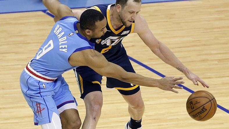 Apr 21, 2021; Houston, Texas, USA;  Houston Rockets guard Avery Bradley (9) reaches for the ball as Utah Jazz guard Joe Ingles (2) tries to drive around during the second half of an NBA basketball game at Toyota Center. Mandatory Credit:  POOL PHOTOS-USA TODAY Sports