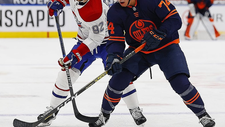 Apr 21, 2021; Edmonton, Alberta, CAN; Edmonton Oilersdefensemen Ethan Bear (74) and Montreal Canadiens forward Jonathan Drouin (92) battle for a loose puck during the first period at Rogers Place. Mandatory Credit: Perry Nelson-USA TODAY Sports