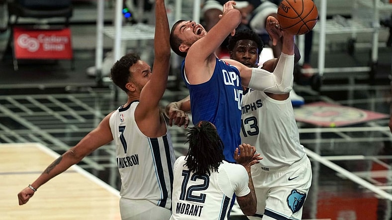 Apr 21, 2021; Los Angeles, California, USA; LA Clippers center Ivica Zubac (40) is defended by Memphis Grizzlies forward Kyle Anderson (1), forward Jaren Jackson Jr. (13) and Ja Morantin the first half at Staples Center. Mandatory Credit: Kirby Lee-USA TODAY Sports