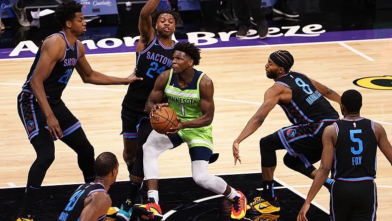 Apr 21, 2021; Sacramento, California, USA; Minnesota Timberwolves forward Anthony Edwards (1) drives in between Sacramento Kings center Hassan Whiteside (20), guard Buddy Hield (24) and forward Maurice Harkless (8) during the second quarter at Golden 1 Center. Mandatory Credit: Kelley L Cox-USA TODAY Sports