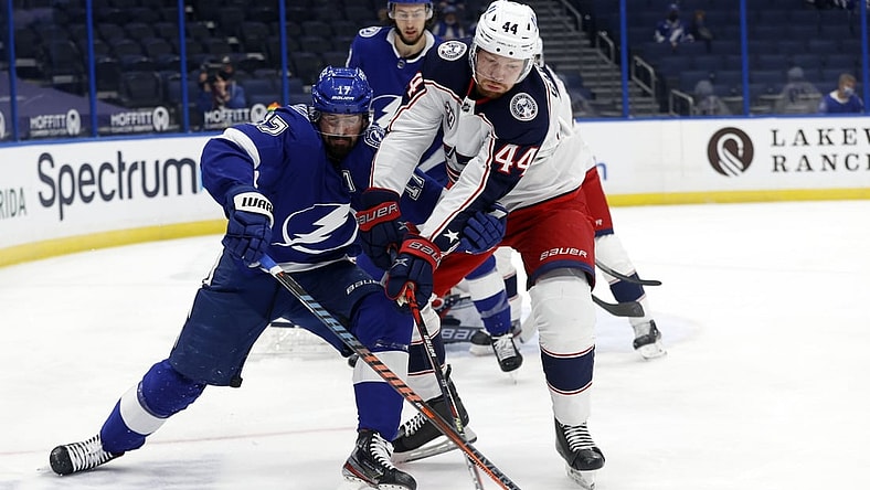 Apr 22, 2021; Tampa, Florida, USA; Tampa Bay Lightning left wing Alex Killorn (17) and Columbus Blue Jackets defenseman Vladislav Gavrikov (44) fight to control the puck during the first period at Amalie Arena. Mandatory Credit: Kim Klement-USA TODAY Sports