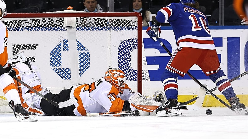 Apr 22, 2021; New York, New York, USA; Artemi Panarin #10 of the New York Rangers heads for the net as Brian Elliott #37 of the Philadelphia Flyers defends in the first period  at Madison Square Garden. Mandatory Credit:  Elsa/POOL PHOTOS-USA TODAY Sports