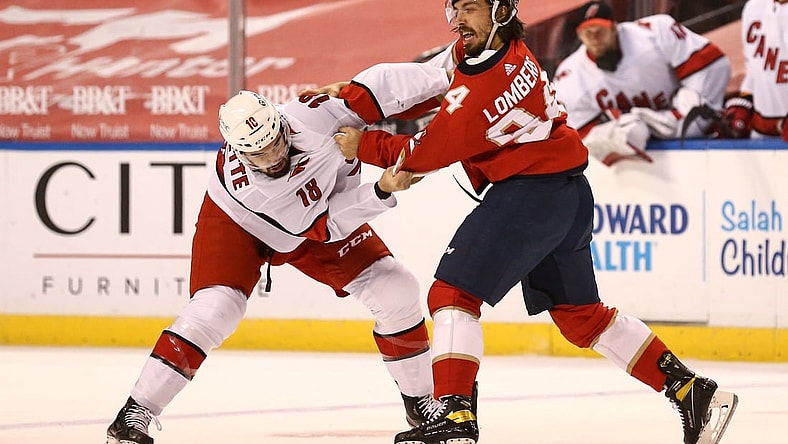 Apr 22, 2021; Sunrise, Florida, USA; Carolina Hurricanes center Cedric Paquette (18) and Florida Panthers left wing Ryan Lomberg (94) fight during the first period at BB&T Center. Mandatory Credit: Sam Navarro-USA TODAY Sports