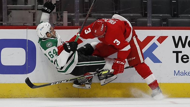 Apr 22, 2021; Detroit, Michigan, USA; Detroit Red Wings defenseman Alex Biega (3) body checks Dallas Stars center Tanner Kero (64) during the first period at Little Caesars Arena. Mandatory Credit: Raj Mehta-USA TODAY Sports