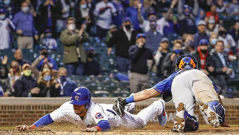Apr 22, 2021; Chicago, Illinois, USA; Chicago Cubs catcher Willson Contreras (40) scores as New York Mets catcher James McCann (33) applies a late tag during the third inning at Wrigley Field. Mandatory Credit: Kamil Krzaczynski-USA TODAY Sports