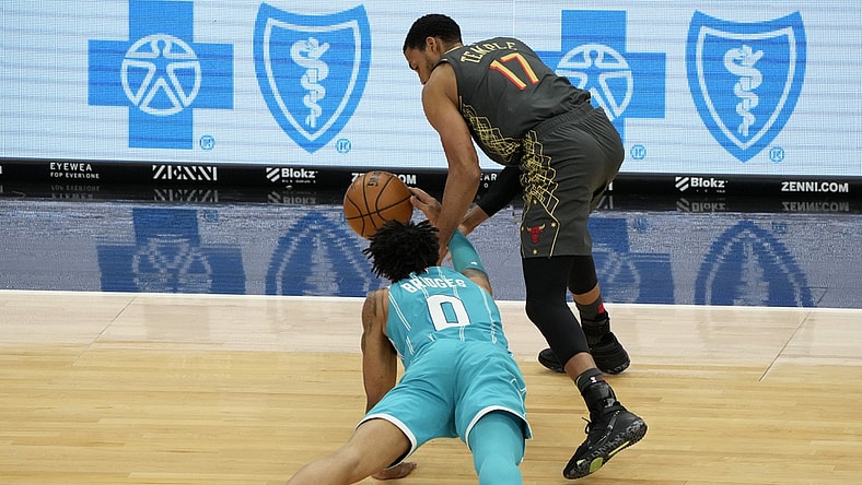 Apr 22, 2021; Chicago, Illinois, USA; Charlotte Hornets forward Miles Bridges (0) attempts to steal the ball from Chicago Bulls forward Garrett Temple (17) during the second quarter at the United Center. Mandatory Credit: Mike Dinovo-USA TODAY Sports