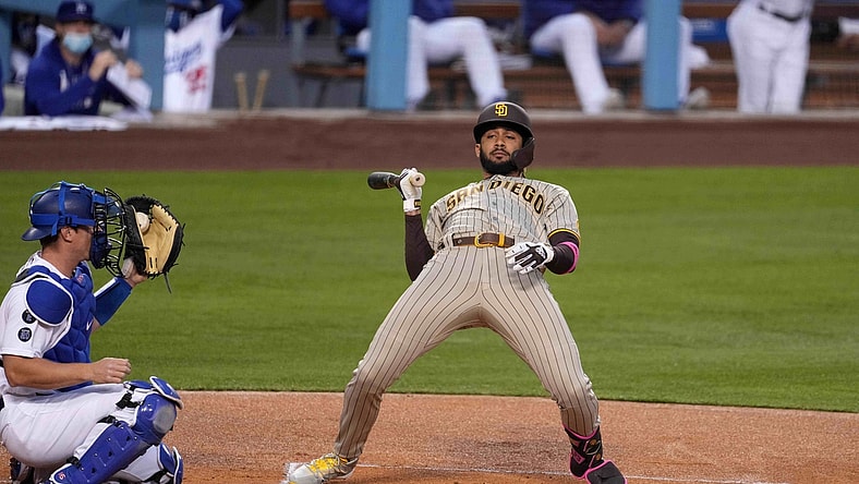 Apr 22, 2021; Los Angeles, California, USA; San Diego Padres shortstop Fernando Tatis Jr. (23) leans to avoid a pitch as Los Angeles Dodgers catcher Will Smith (16) watches in the first inning at Dodger Stadium. Mandatory Credit: Kirby Lee-USA TODAY Sports