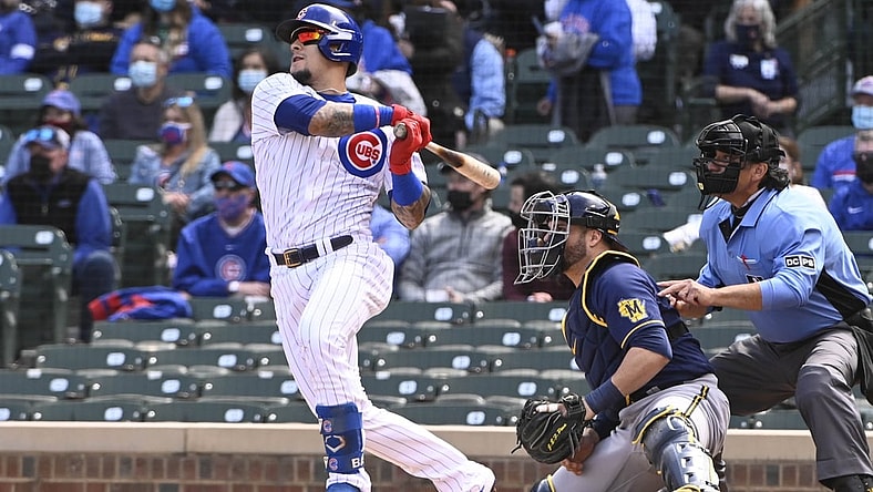 Apr 23, 2021; Chicago, Illinois, USA; Chicago Cubs shortstop Javier Baez (9) hits a home run against the Milwaukee Brewers in the second inning  at Wrigley Field. Mandatory Credit: Matt Marton-USA TODAY Sports