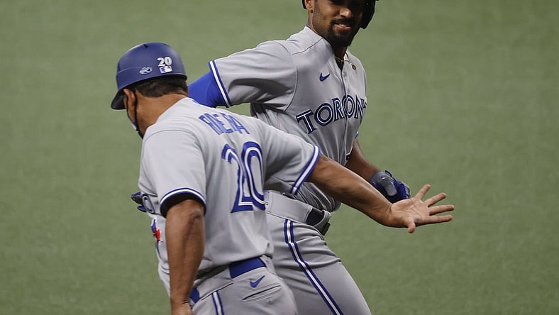 Apr 23, 2021; St. Petersburg, Florida, USA; Toronto Blue Jays shortstop Marcus Semien (R) is congratulated after hitting a three-run home run during the first inning against the Tampa Bay Rays at Tropicana Field. Mandatory Credit: Kim Klement-USA TODAY Sports