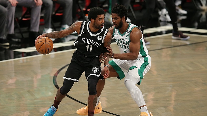 Apr 23, 2021; Brooklyn, New York, USA; Brooklyn Nets point guard Kyrie Irving (11) dribbles the ball while defended by Boston Celtics power forward Semi Ojeleye (37) during the first quarter at Barclays Center. Mandatory Credit: Brad Penner-USA TODAY Sports