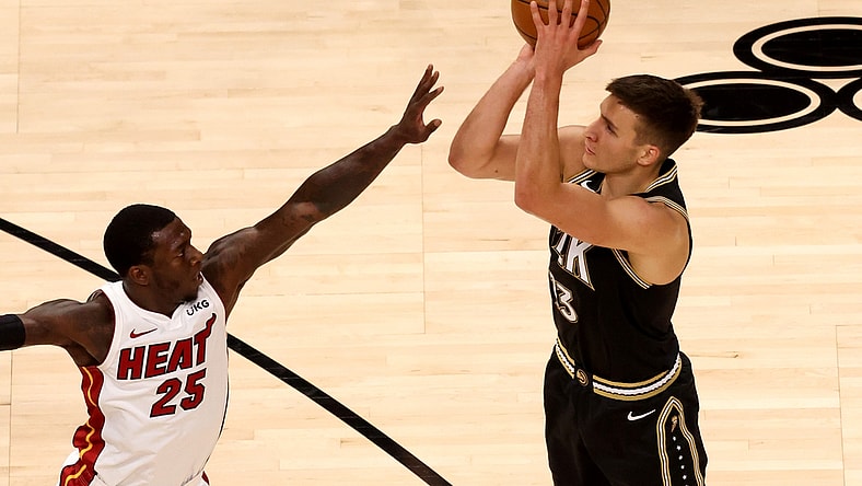 Apr 23, 2021; Atlanta, Georgia, USA; Atlanta Hawks guard Bogdan Bogdanovic (13) attempts a three-point basket against Miami Heat guard Kendrick Nunn (25) during the first quarter at State Farm Arena. Mandatory Credit: Jason Getz-USA TODAY Sports