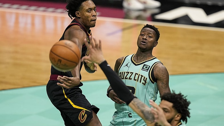 Apr 23, 2021; Charlotte, North Carolina, USA; Cleveland Cavaliers guard Collin Sexton (L) passes the ball in front of Charlotte Hornets guard Terry Rozier (C) during the first quarter at the Spectrum Center. Mandatory Credit: Jim Dedmon-USA TODAY Sports