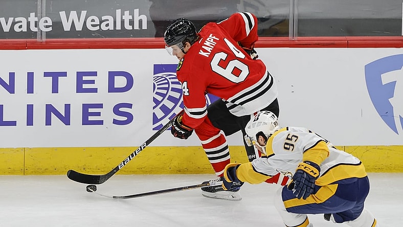 Apr 23, 2021; Chicago, Illinois, USA; Chicago Blackhawks center David Kampf (64) keeps the puck away from Nashville Predators center Matt Duchene (95) during the first period at United Center. Mandatory Credit: Kamil Krzaczynski-USA TODAY Sports