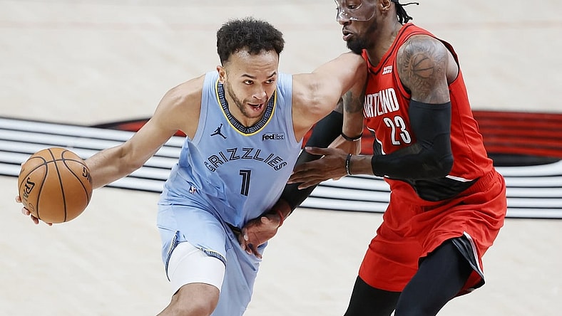 Apr 23, 2021; Portland, Oregon, USA; Memphis Grizzlies small forward Kyle Anderson (1) dribbles the ball as Portland Trail Blazers power forward Robert Covington (23) defends during the second half at Moda Center. Mandatory Credit: Soobum Im-USA TODAY Sports