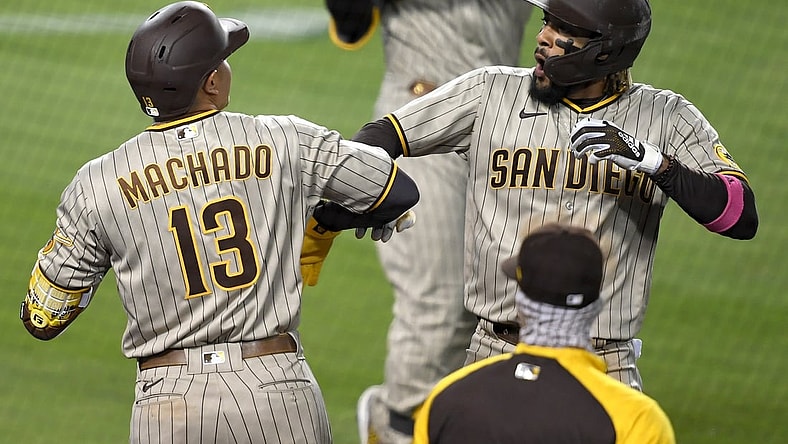 Apr 23, 2021; Los Angeles, California, USA;  San Diego Padres shortstop Fernando Tatis Jr. (23) is greeted by third baseman Manny Machado (13) after hitting a solo home run in the third inning of the game against the Los Angeles Dodgers at Dodger Stadium. Mandatory Credit: Jayne Kamin-Oncea-USA TODAY Sports