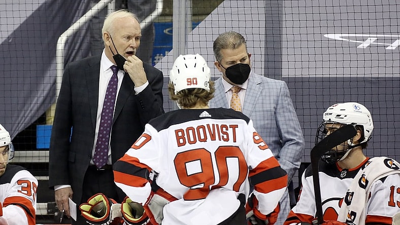 Apr 20, 2021; Pittsburgh, Pennsylvania, USA;  New Jersey Devils head coach Lindy Ruff (left) reacts on the bench against the Pittsburgh Penguins during the second period at PPG Paints Arena. Mandatory Credit: Charles LeClaire-USA TODAY Sports