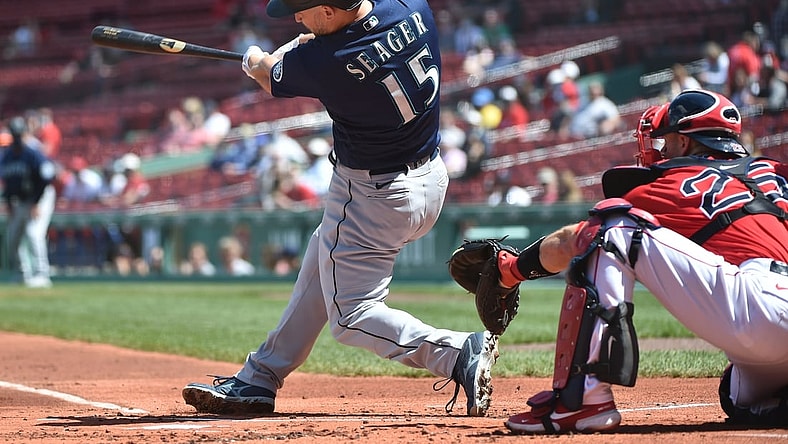 Apr 24, 2021; Boston, Massachusetts, USA;  Seattle Mariners third baseman Kyle Seager (15) hits an RBI single during the first inning against the Boston Red Sox at Fenway Park. Mandatory Credit: Bob DeChiara-USA TODAY Sports