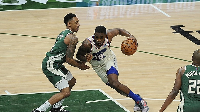Apr 24, 2021; Milwaukee, Wisconsin, USA;  Philadelphia 76ers guard Shake Milton (18) drives to the basket against Milwaukee Bucks guard Jeff Teague (5) in the second quarter at Fiserv Forum. Mandatory Credit: Michael McLoone-USA TODAY Sports