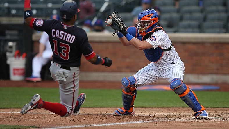 Apr 24, 2021; New York City, New York, USA; Washington Nationals infielder Starlin Castro (13) is tagged out trying to score by New York Mets catcher James McCann (33) on a bunt by Nationals starting pitcher Joe Ross (not pictured) during the fifth inning at Citi Field. Mandatory Credit: Brad Penner-USA TODAY Sports