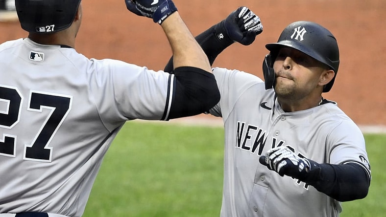 Apr 24, 2021; Cleveland, Ohio, USA; New York Yankees second baseman Rougned Odor (right) celebrates with designated hitter Giancarlo Stanton (27) after hitting a solo home run against the Cleveland Indians in the fifth inning at Progressive Field. Mandatory Credit: David Richard-USA TODAY Sports