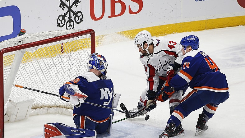 Apr 24, 2021; Uniondale, New York, USA; New York Islanders goaltender Ilya Sorokin (30) defends his net as center Jean-Gabriel Pageau (44) checks Washington Capitals right wing Tom Wilson (43) off the puck during the first at Nassau Veterans Memorial Coliseum. Mandatory Credit: Andy Marlin-USA TODAY Sports