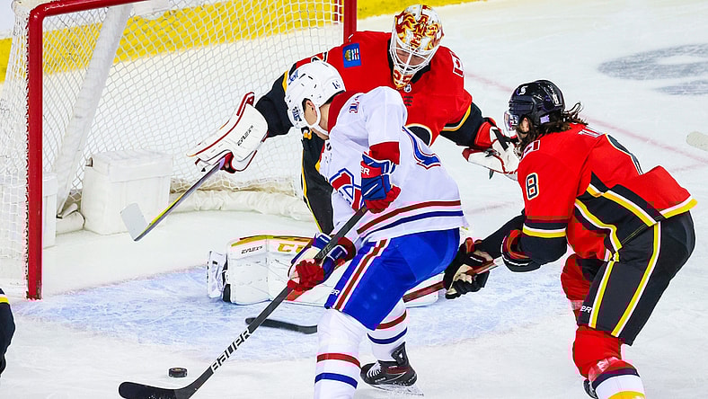 Apr 24, 2021; Calgary, Alberta, CAN; Montreal Canadiens center Nick Suzuki (14) scores a goal against Calgary Flames goaltender Jacob Markstrom (25) during the first period at Scotiabank Saddledome. Mandatory Credit: Sergei Belski-USA TODAY Sports