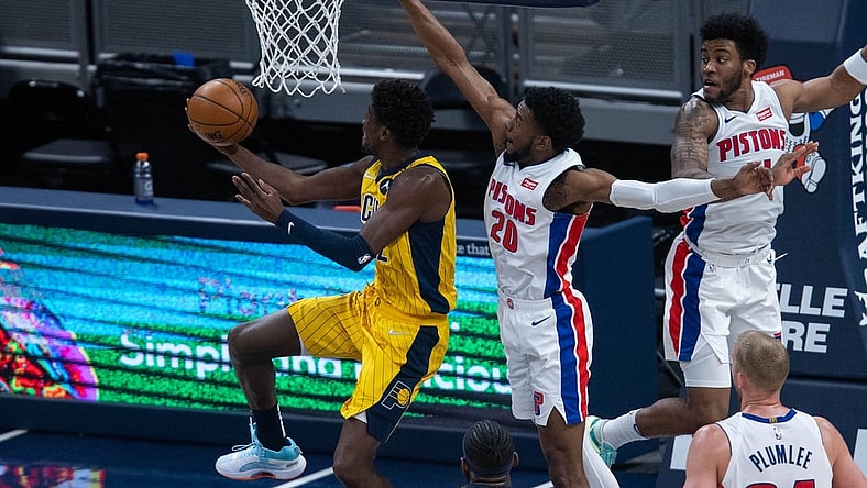 Apr 24, 2021; Indianapolis, Indiana, USA; Indiana Pacers guard Caris LeVert (22) shoots the ball while Detroit Pistons guard Josh Jackson (20) defends in the third quarter at Bankers Life Fieldhouse. Mandatory Credit: Trevor Ruszkowski-USA TODAY Sports