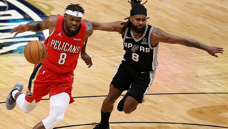 Apr 24, 2021; New Orleans, Louisiana, USA; New Orleans Pelicans forward Naji Marshall (left) dribbles the ball against San Antonio Spurs guard Patty Mills (right) during the first quarter at the Smoothie King Center. Mandatory Credit: Chuck Cook-USA TODAY Sports