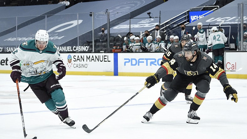Apr 24, 2021; Anaheim, California, USA; Anaheim Ducks center Sam Steel (23) handles the puck while Vegas Golden Knights defenseman Nicolas Hague (14) defends during the first period at Honda Center. Mandatory Credit: Kelvin Kuo-USA TODAY Sports
