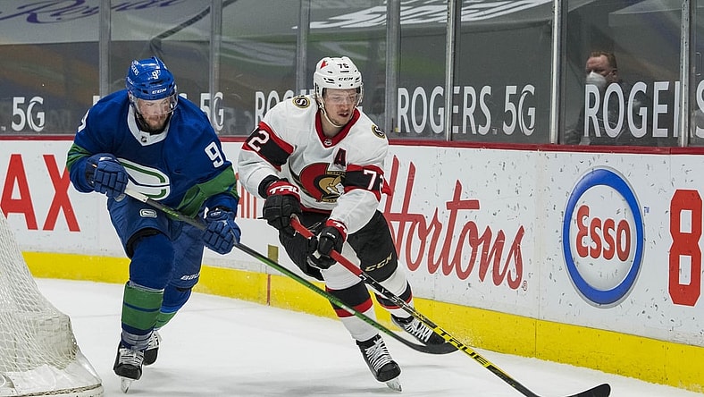 Apr 24, 2021; Vancouver, British Columbia, CAN;  Vancouver Canucks forward J.T. Miller (9) checks Ottawa Senators defenseman Thomas Chabot (72) in the second period at Rogers Arena. Mandatory Credit: Bob Frid-USA TODAY Sports