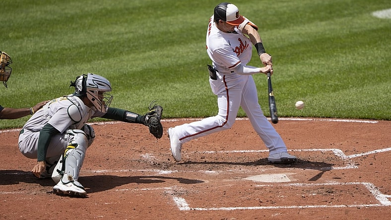 Apr 25, 2021; Baltimore, Maryland, USA; Baltimore Orioles right fielder Austin Hays (21) hits a home run during the fourth inning against the Oakland Athletics at Oriole Park at Camden Yards. Mandatory Credit: Gregory Fisher-USA TODAY Sports