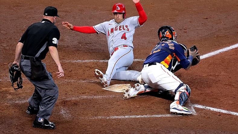 Apr 25, 2021; Houston, Texas, USA; Los Angeles Angels shortstop Jose Iglesias (4) slides across home plate to score a run against the Houston Astros during the fifth inning at Minute Maid Park. Mandatory Credit: Erik Williams-USA TODAY Sports