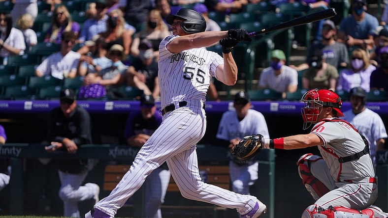 Apr 25, 2021; Denver, Colorado, USA; Colorado Rockies starting pitcher Jon Gray (55) hits a RBI single in the fourth inning against the Philadelphia Phillies Coors Field. Mandatory Credit: Ron Chenoy-USA TODAY Sports