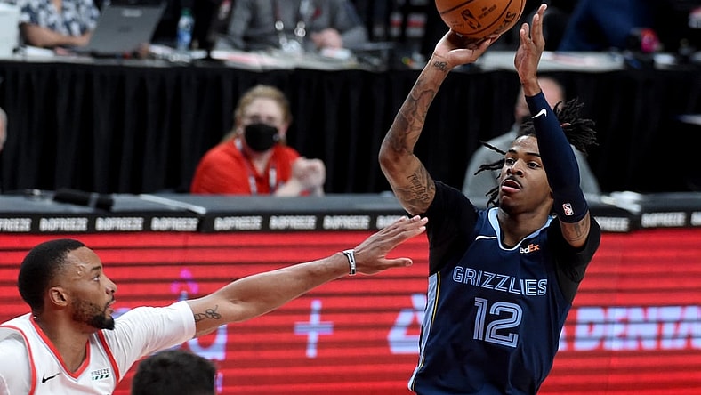 Apr 25, 2021; Portland, Oregon, USA; Memphis Grizzlies guard Ja Morant (12) shoot the ball on Portland Trail Blazers forward Norman Powell (24) during the first half of the game at Moda Center. Mandatory Credit: Steve Dykes-USA TODAY Sports