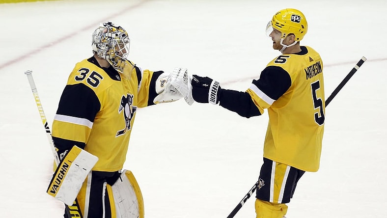 Apr 25, 2021; Pittsburgh, Pennsylvania, USA;  Pittsburgh Penguins defenseman Mike Matheson (5) congratulates Pittsburgh Penguins goaltender Tristan Jarry (35) on his shutout of the Boston Bruins at PPG Paints Arena. The Penguins shutout the Bruins 1-0. Mandatory Credit: Charles LeClaire-USA TODAY Sports
