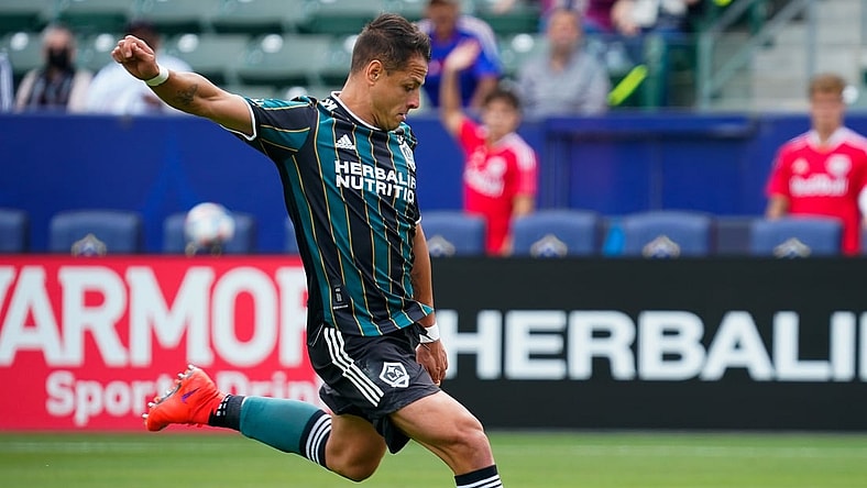 Apr 25, 2021; Carson, California, USA; Los Angeles Galaxy forward Javier Hernandez (14) shoots and scores his second goal of the first half against the New York Red Bulls at Dignity Health Sports Park. Mandatory Credit: Robert Hanashiro-USA TODAY Sports
