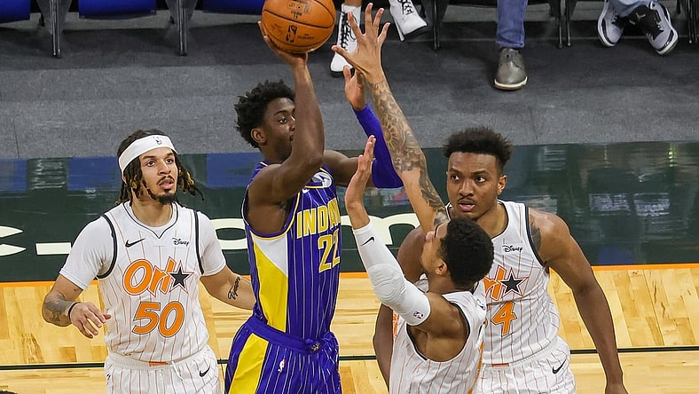 Apr 25, 2021; Orlando, Florida, USA; Indiana Pacers guard Caris LeVert (22) shoots the ball over Orlando Magic forward Chuma Okeke (3) and center Wendell Carter Jr. (34) as Orlando Magic guard Cole Anthony (50) looks on during the first quarter at Amway Center. Mandatory Credit: Mike Watters-USA TODAY Sports