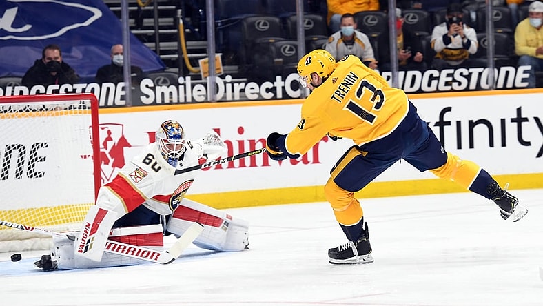 Apr 26, 2021; Nashville, Tennessee, USA; Nashville Predators center Yakov Trenin (13) shoots wide of Florida Panthers goaltender Chris Driedger (60) during the first period at Bridgestone Arena. Mandatory Credit: Christopher Hanewinckel-USA TODAY Sports