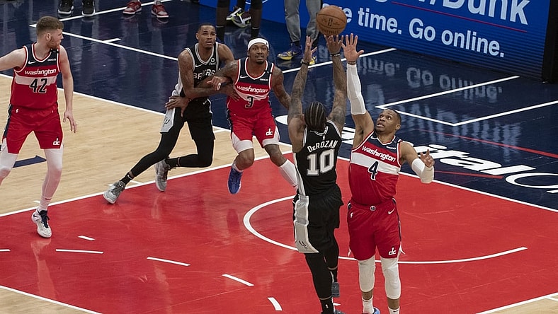 Apr 26, 2021; Washington, District of Columbia, USA;  Washington Wizards guard Russell Westbrook (4) contests ]San Antonio Spurs forward DeMar DeRozan (10) shoot as time expires during the second  half at Capital One Arena. Mandatory Credit: Tommy Gilligan-USA TODAY Sports