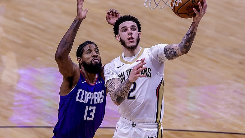 Apr 26, 2021; New Orleans, Louisiana, USA;  New Orleans Pelicans guard Lonzo Ball (2) drives to the basket against LA Clippers guard Paul George (13) during the second half at the Smoothie King Center. Mandatory Credit: Stephen Lew-USA TODAY Sports
