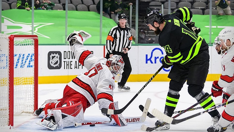 Apr 26, 2021; Dallas, Texas, USA; Dallas Stars left wing Jamie Benn (14) scores the game winning goal against Carolina Hurricanes goaltender James Reimer (47) during the overtime period at the American Airlines Center. Mandatory Credit: Jerome Miron-USA TODAY Sports
