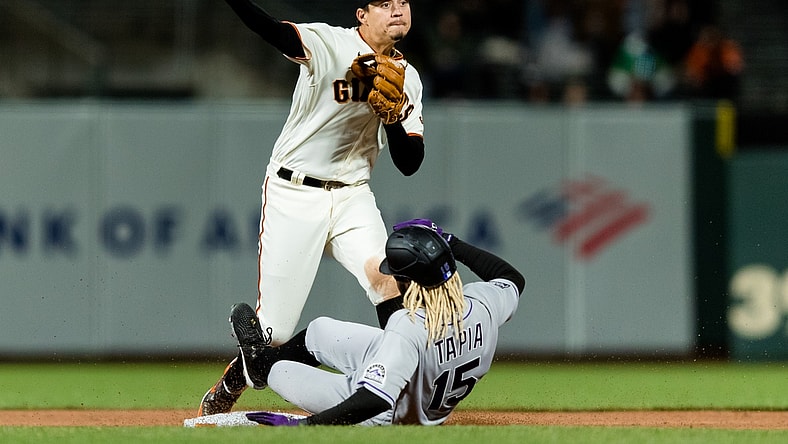 Apr 26, 2021; San Francisco, California, USA;  San Francisco Giants shortstop Mauricio Dubon (1) tags Colorado Rockies left fielder Raimel Tapia (15) but is late for the double play at first base in the sixth inning at Oracle Park. Mandatory Credit: John Hefti-USA TODAY Sports