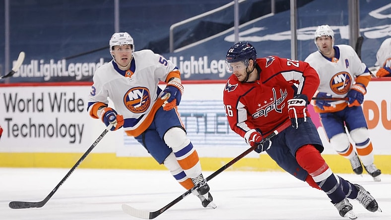 Apr 27, 2021; Washington, District of Columbia, USA; Washington Capitals center Nic Dowd (26) skates with the puck as New York Islanders center Casey Cizikas (53) defends in the first period at Capital One Arena. Mandatory Credit: Geoff Burke-USA TODAY Sports