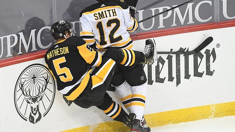 Apr 27, 2021; Pittsburgh, Pennsylvania, USA;  Boston Bruins center Craig Smith (12) and Pittsburgh Penguins defenseman  Mike Matheson (5) crash into each other during the first period at PPG Paints Arena. Mandatory Credit: Philip G. Pavely-USA TODAY Sports