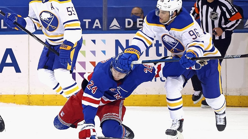 Apr 27, 2021; New York, NY, USA;  Anders Bjork #96 of the Buffalo Sabres checks Kaapo Kakko #24 of the New York Rangers during the first period at Madison Square Garden on April 27, 2021 in New York City.  Mandatory Credit: Bruce Bennett/Pool Photo-USA TODAY Sports