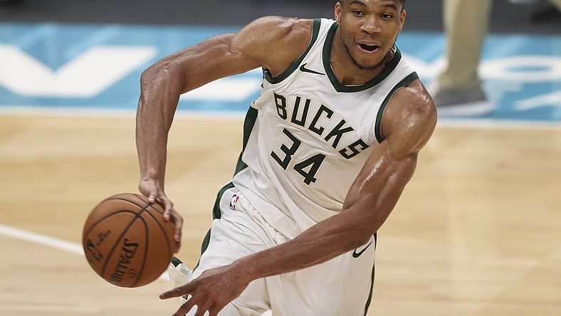 Apr 27, 2021; Charlotte, North Carolina, USA; Milwaukee Bucks forward Giannis Antetokounmpo (34) passes the basketball against the Charlotte Hornets during the second quarter at Spectrum Center. Mandatory Credit: Nell Redmond-USA TODAY Sports