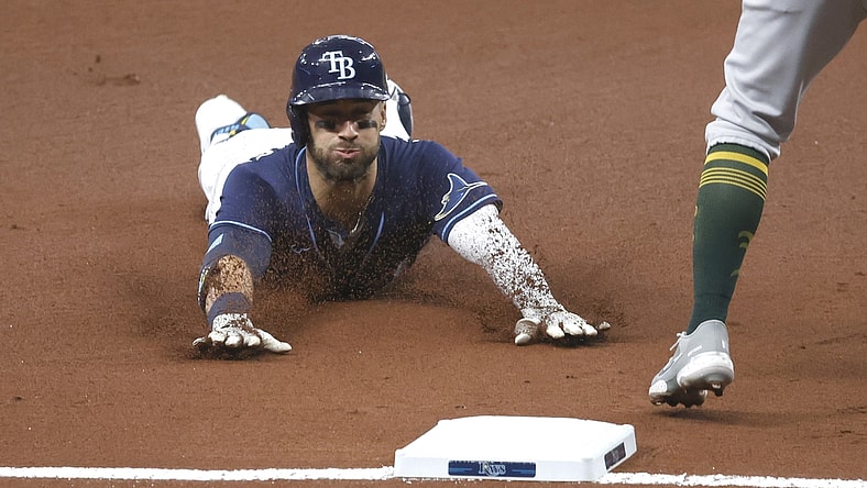 Apr 27, 2021; St. Petersburg, Florida, USA; Tampa Bay Rays center fielder Kevin Kiermaier (39) slides into third base as he triples during the first inning against the Oakland Athletics at Tropicana Field. Mandatory Credit: Kim Klement-USA TODAY Sports