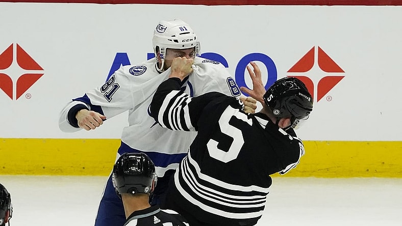 Apr 27, 2021; Chicago, Illinois, USA; Tampa Bay Lightning defenseman Erik Cernak (81) and Chicago Blackhawks defenseman Connor Murphy (5) fight during the second period at United Center. Mandatory Credit: David Banks-USA TODAY Sports